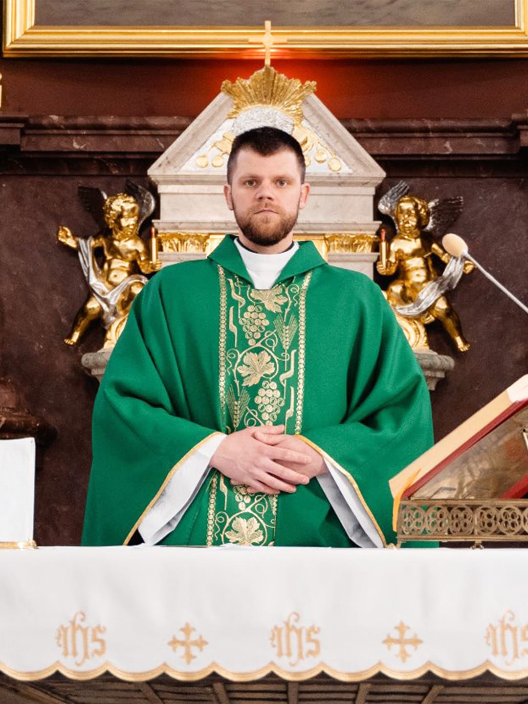 Priest standing in front of church