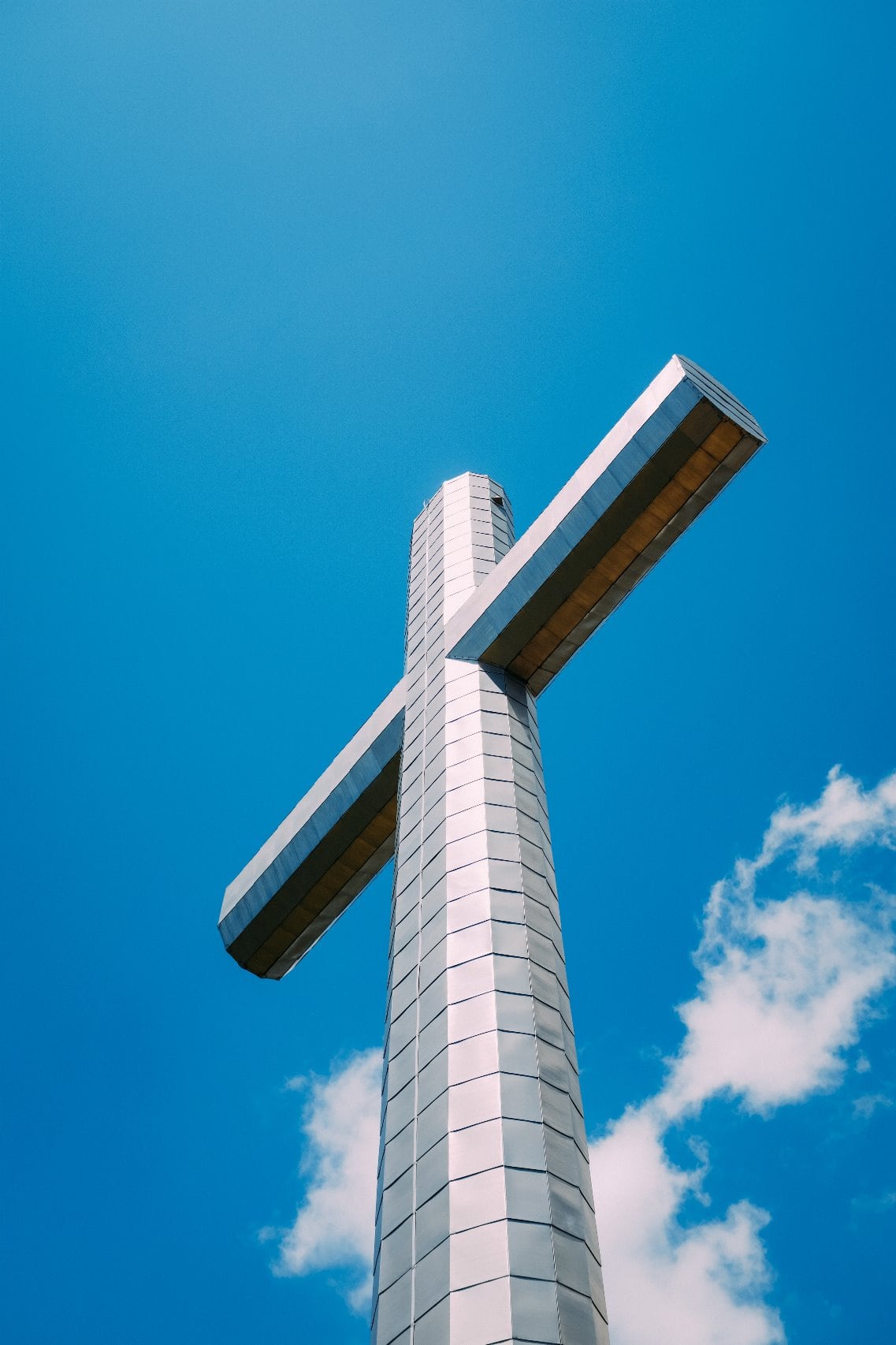 Metal Christian cross against blue sky