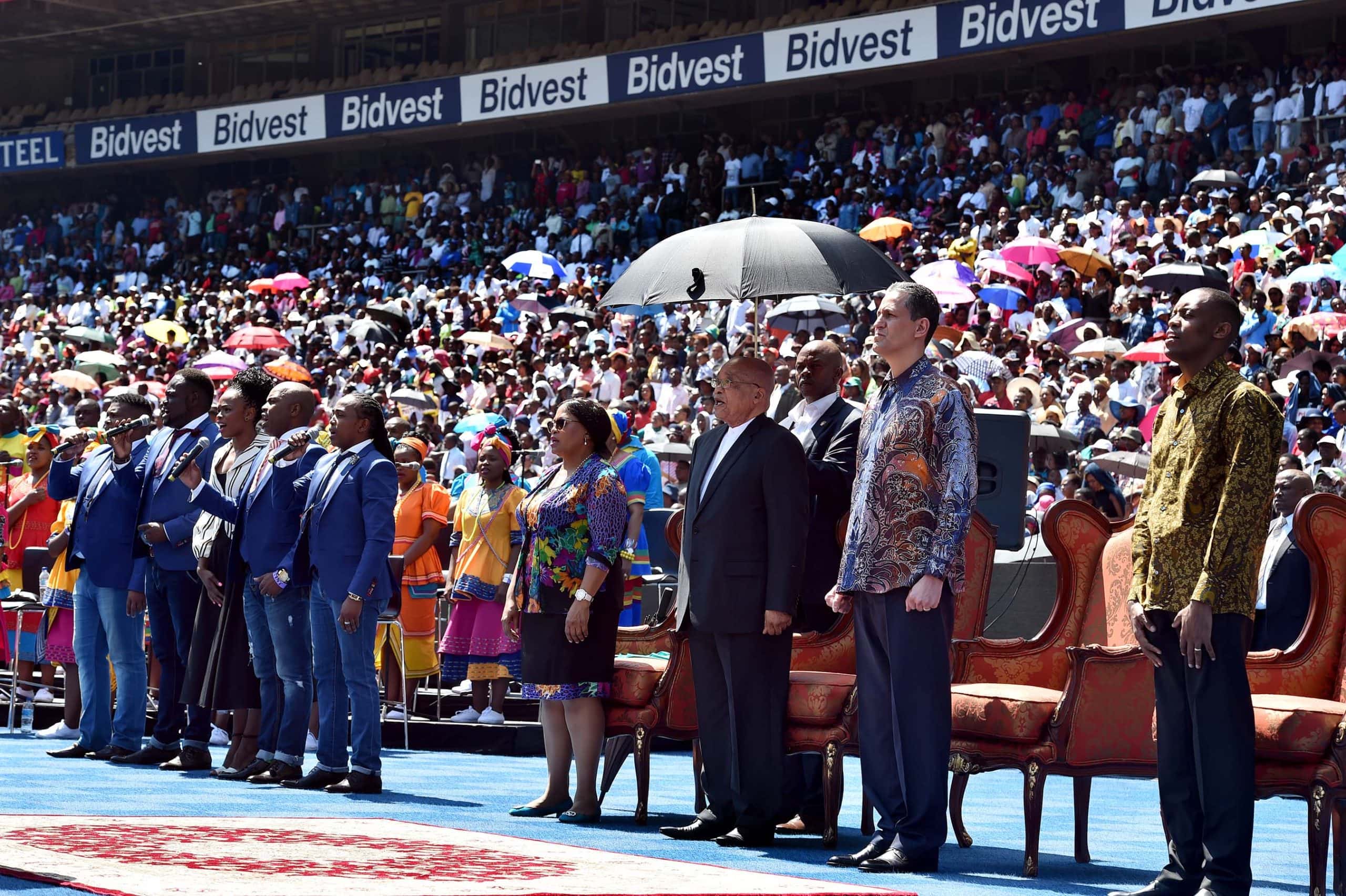 resident Zuma flanked by Minister Nomvula Mokonyane and Bishop Marcerlo during the singing of the National Anthem at the Good Friday Church Service).